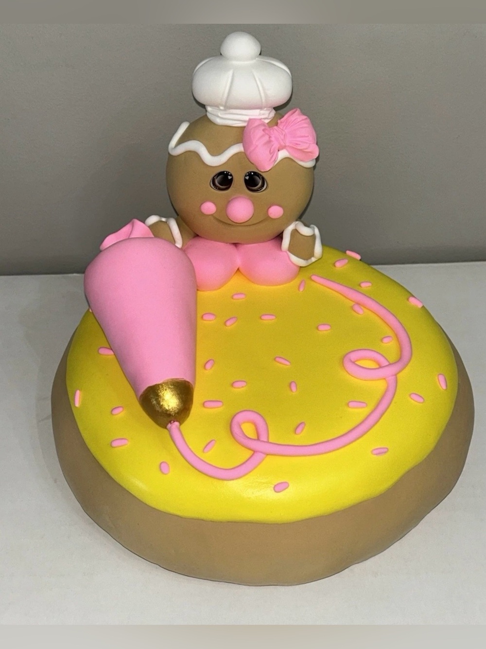 Whimsical Pink & Yellow Fake Gingerbread Baker on Giant Sugar Cookie Display